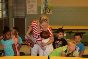 Carmen hugging a reading buddy at Taylor ISD